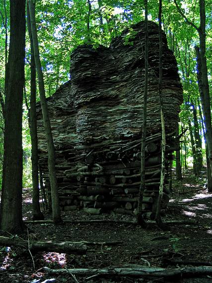 July 23, 2005 - Stone Quary Hill Sculpture Park, Cazenovia, New York.<br />A sculpture, "Facing, Love 30", make of wood and newspapers, 12' x 20' x 17 (1999)  by Steven Siegel.