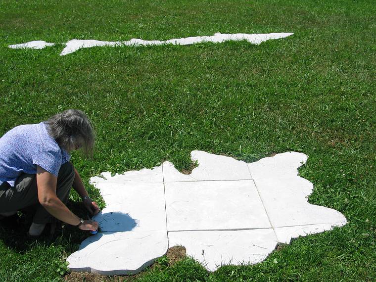 July 23, 2005 - Stone Quary Hill Sculpture Park, Cazenovia, New York.<br />Joyce trimming the grass from around "Red Fir Footprint, Mendocino National Forest, CA",<br />part of her "Stone Quarry Triad".