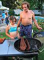 September 3, 2005 - Lawrence, Massachusetts.<br />Another family gathering at Memere Marie's pool on a hot summer day.<br />Arianna and Paul checking the spare ribs.