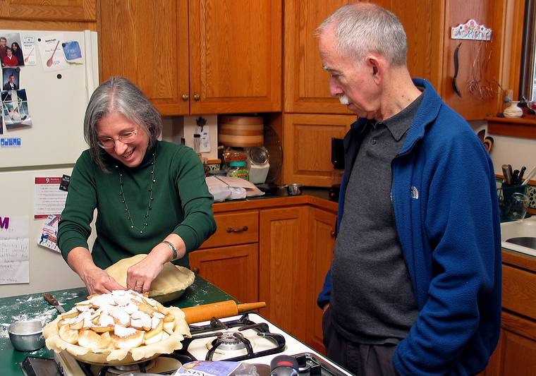 Ronnie watching Joyce prepare her apple pie.<br />Dec. 24, 2005 - Merrimac, Massachusetts.