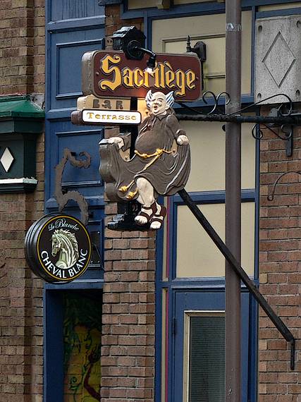 April 15, 2006 - Quebec City, Quebec, Canada.<br />The Sacrilege Bar sign on Rue St-Jean across the street from Saint-Jean-Baptiste Church.