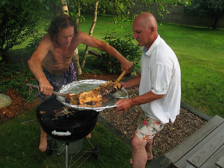 July 4, 2006 - At Uncle Tom's cabin, South Hampton, New Hampshire.<br />The salmon is ready! Paul and Tom dealing with it.