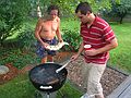 July 4, 2006 - At Uncle Tom's cabin, South Hampton, New Hampshire.<br />TJ adjusting the grill for Paul for a second salmon.