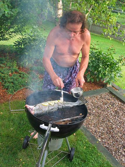 July 4, 2006 - At Uncle Tom's cabin, South Hampton, New Hampshire.<br />Paul fine tuning the salmon.