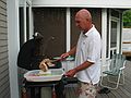 July 4, 2006 - At Uncle Tom's cabin, South Hampton, New Hampshire.<br />Tom grilling the meat.