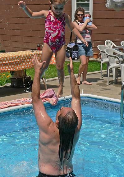 July 16. 2006 - Lawrence, Massachusetts.<br />Celebrating Holly's birthday.<br />Carl throwing Miranda while Holly, holding Matthew, is watching.