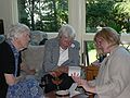 August 26, 2006 - Manchester by the Sea, Massachusetts.<br />Edite's birthday celebration.<br />Mirdza, Marie, and Laila looking at Laila's photographs.