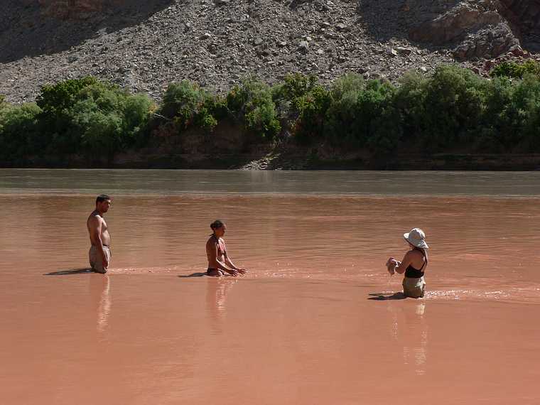 August 16, 2006 - Day 5, now on the Colorado River, Utah.<br />Sati, Melody, and Joyce in the Green River water with the Colorado River Water in back.<br />The Green River was redder due to last nights prolonged thunderstorm with heavy rains.