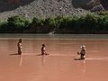 August 16, 2006 - Day 5, now on the Colorado River, Utah.<br />Sati, Melody, and Joyce in the Green River water with the Colorado River Water in back.<br />The Green River was redder due to last nights prolonged thunderstorm with heavy rains.