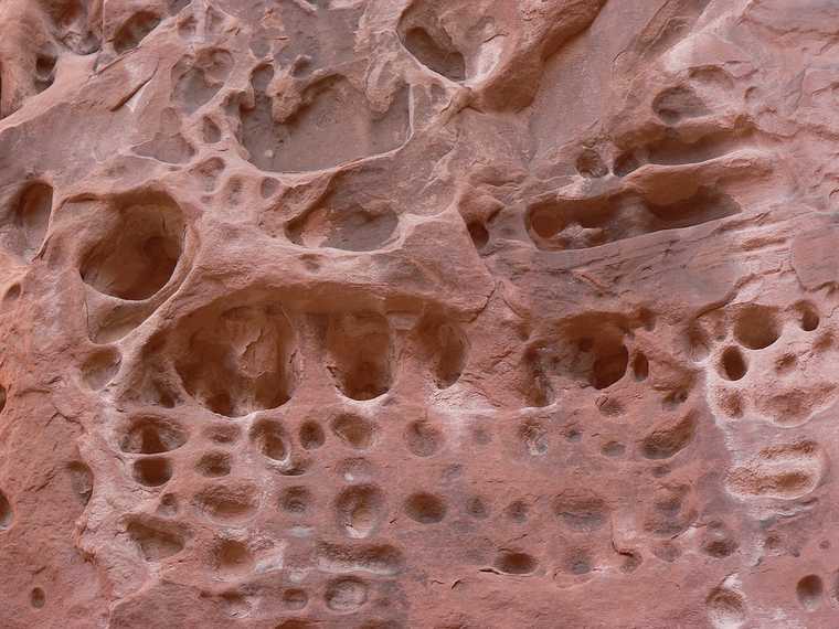 August 18, 2006 - Arches National Park, Utah.<br />A guided tour through Fiery Furnace, the coolest place in the park.<br />Holes left in the wall of canyons due to water seepage.
