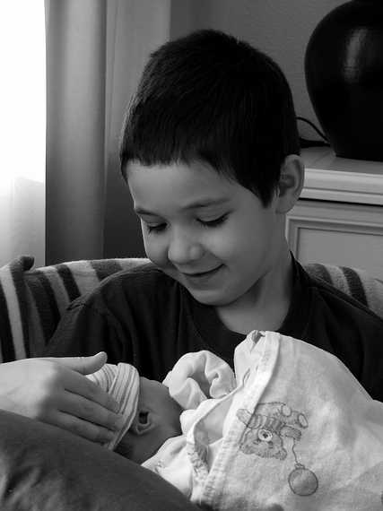 March 25, 2007 - Vogar, Iceland.<br />Gujn holding his day old brother Marks.