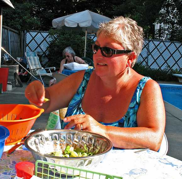 July 27, 2007 - Lawrence, Massachusetts.<br />Norma shelling Paul's peas while Joyce shucks corn in the background.