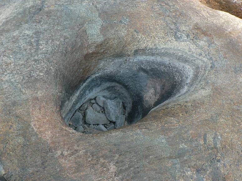 August 15, 2007 - Sequoia National Forest, California.<br />At the canyoneering trip start on Ten Mile Creek.<br />A hole in the boulder dug by the rocks inside it.