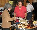 Nov. 22, 2007 - Thanksgiving dinner at Paul and Norma's, Tewksbury, Massachusetts.<br />Joyce and Paul filling a plate for Frank, Paul and Norma's tenant upstairs.