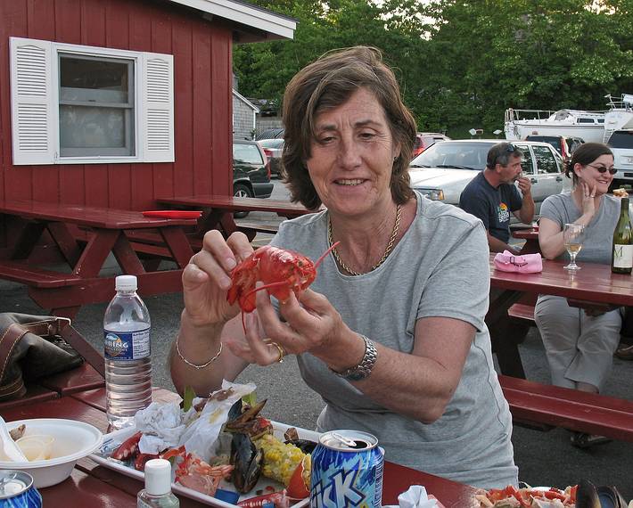 June 12, 2008 - South Freeport, Maine.<br />Harraseeket Lobster - eat in the rought.<br />Asuncion reassembles her lobster for the photo.