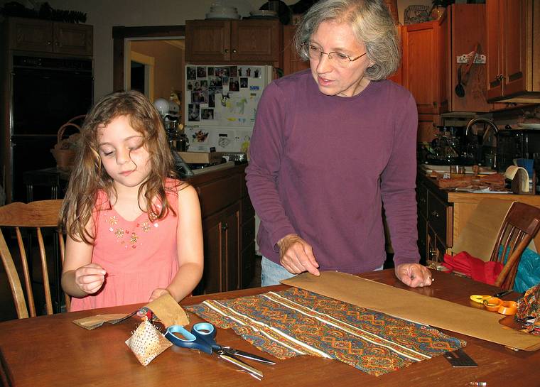 June 29, 2008 - Merrimac, Massachusetts.<br />Miranda and Joyce making an apron for Miranda.<br />Miranda pinning under Joyce's supervision.