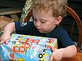 June 29, 2008 - Mendon, Massachusetts.<br />Matthew's 2nd birthday celebration.<br />Matthew meticulously opening one of his presents.