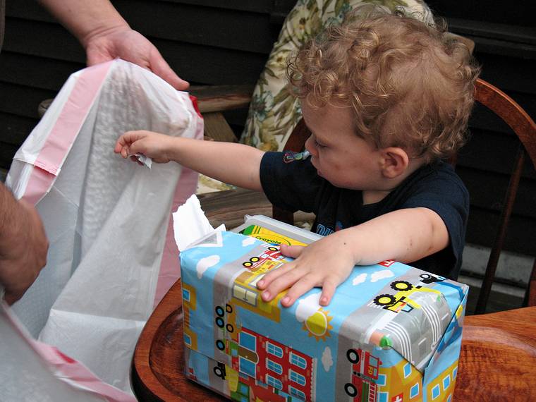 June 29, 2008 - Mendon, Massachusetts.<br />Matthew's 2nd birthday celebration.<br />Matthew meticulously opening one of his presents.