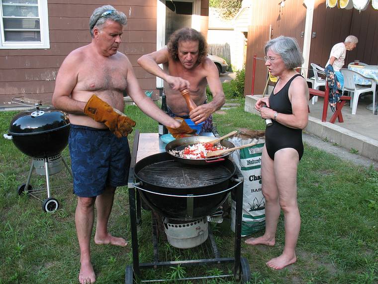 July 13, 2008 - Lawrence, Massachusetts.<br />The making of a Spanish paella (Time-Life: The Cooking of Spain and Portugal).<br />Paul and Joyce adding pepper and salt to the sofrito while Jim holds the hot pan.