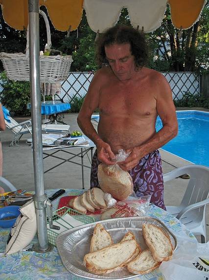 July 13, 2008 - Lawrence, Massachusetts.<br />The making of a Spanish paella (Time-Life: The Cooking of Spain and Portugal).<br />Paul slicing the Portugese bread.