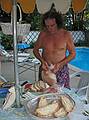 July 13, 2008 - Lawrence, Massachusetts.<br />The making of a Spanish paella (Time-Life: The Cooking of Spain and Portugal).<br />Paul slicing the Portugese bread.