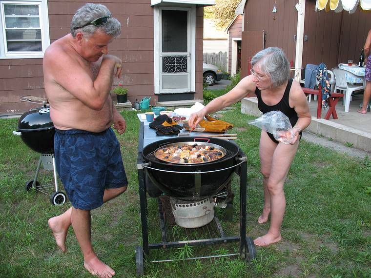 July 13, 2008 - Lawrence, Massachusetts.<br />The making of a Spanish paella (Time-Life: The Cooking of Spain and Portugal).<br />Jim watches Joyce adding red peppers.