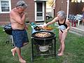 July 13, 2008 - Lawrence, Massachusetts.<br />The making of a Spanish paella (Time-Life: The Cooking of Spain and Portugal).<br />Jim watches Joyce adding red peppers.