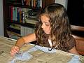 August 3, 2008 - Merrimac, Massachusetts.<br />Miranda in the process of cutting out a dress pattern for a dress for herself<br />(under Joyce's tutelage).