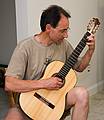 August 10, 2008 - Merrimack, Massachusetts.<br />Open house at Joyce's studio.<br />Oscar entertaining us by playing one of his self-made guitars.