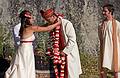 Sept. 6, 2008 - Melody's and Sati's Wedding at Mono Hot Springs, California.<br />Melody placing a garland on Sati with Andre watching.