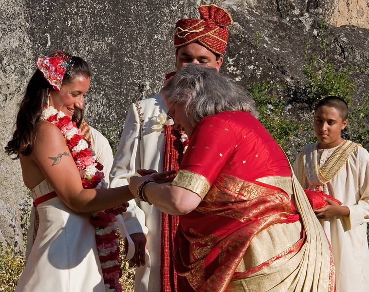 Sept. 6, 2008 - Melody's and Sati's Wedding at Mono Hot Springs, California.<br />Sargam placing white and red bracelets, sign of a married woman, on Melody with Sati and Anoo watching.