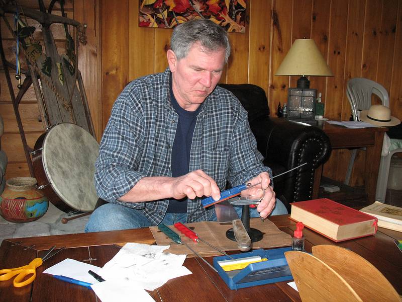 April 5, 2009 - At Bill and Carol's log cabin in Campton, New Hampshire.<br />Chris sharpening one of Carol's kitchen knives.