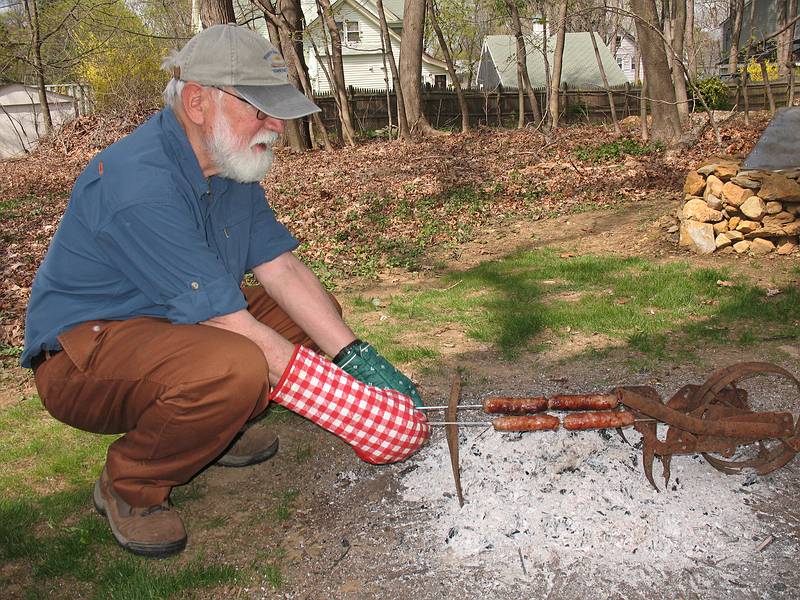 April 26, 2009 - Merrimac, Massachusetts.<br />Egils cooking Fowles sausages, two bratwursts and two kielbasas,<br />over the remains of the brush fire. They were yummy!
