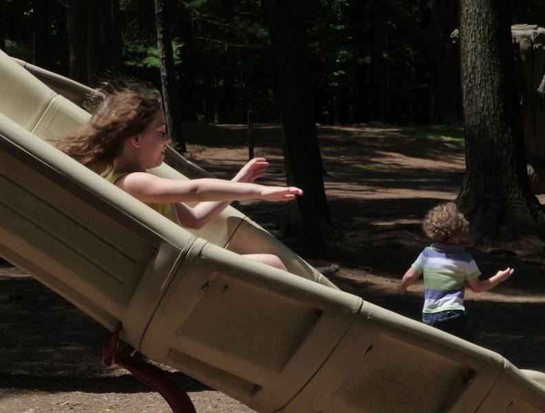 July 11, 2009 - Moseley Woods Park, Newburyport, Massachusetts.<br />Miranda on the slide with Matthew in the background.
