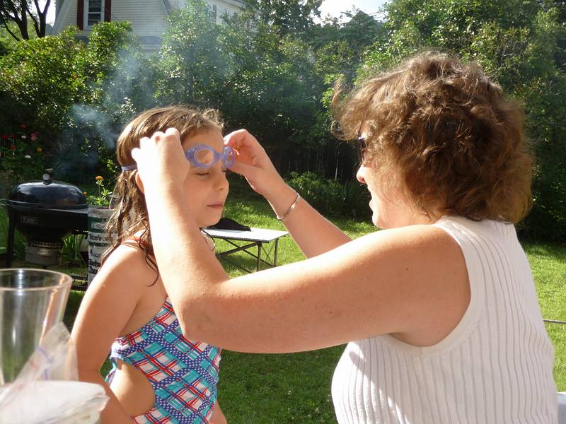 July 19, 2009 - At Marie's in Lawrence, Massachusetts.<br />Holly adjusting Miranda's swimming goggles.