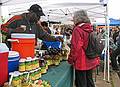 Oct. 31, 2009 - Waverly Farmers' Market, Barclay & E. 32nd Streets, Baltimore, Maryland.<br />Joyce buying some spicy sauce.