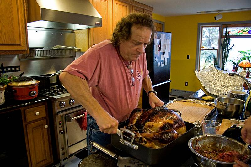 Nov. 26, 2009 - Thanksgiving at Paul and Norma's in Tewksbury, Massachusetts.<br />Paul trying to lift the turkey onto the cutting board (Carl had to help).