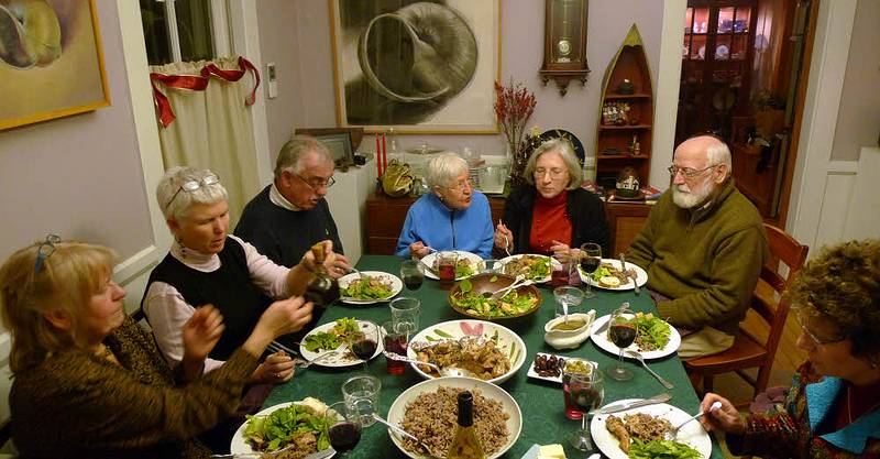 Dec. 23, 2009 - Christmas tree decorating party in Merrimac, Massachusetts.<br />The other end of the table: Nancy, Deb, Ray, Marie, Joyce, Egils, and Bonnie<br />enjoying the chicken Marbella that Joyce prepared (at Sati's request).