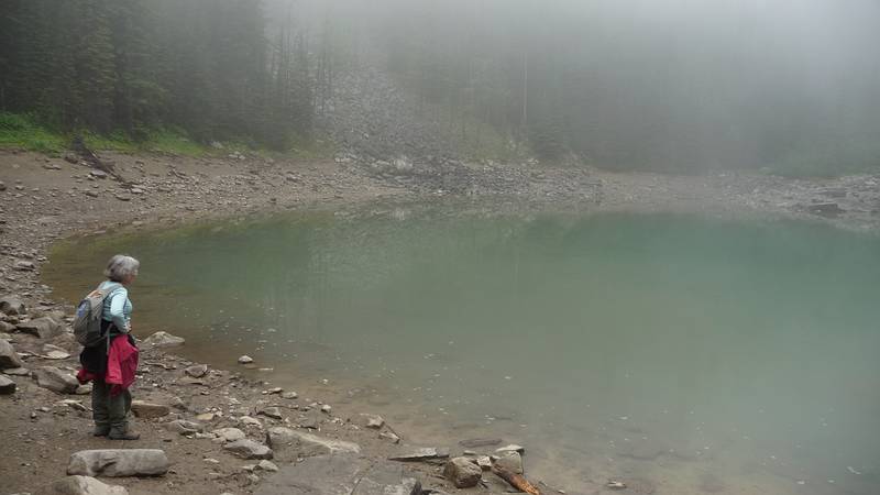 August 5, 2009 - Lake Louise area of Banff National Park, Alberta, Canada.<br />Along trail to Lake Agnes tea house.<br />Joyce at small tarn near below Lake Agnes.