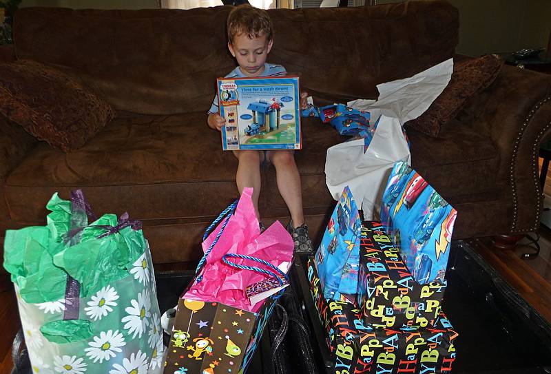 Matthew surrounded my a new set of presents at home.<br />Celebrating Matthew's 4th birthday.<br />June 27, 2010 - Mendon, Massachusetts.