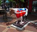 Note the woman and a second figure painted on the cow.<br />Along Church Street.<br />June 9, 2010 - Burlington, Vermont.