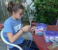 Hannah making friendship bracelets.<br />July 3, 2010 - At Marie's in Lawrence, Massachusetts.
