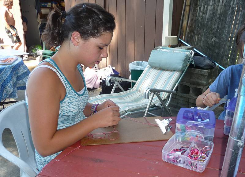 Arianna making friendship bracelets.<br />July 3, 2010 - At Marie's in Lawrence, Massachusetts.