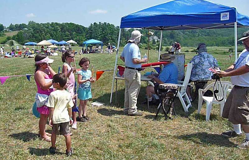Miranda and friends being photographed while they wait to turn in their launch cards.<br />A Central Massachusetts Spacemodeling Society (CMASS) event.<br />July 17, 2010 - Woodsom Farm, Amesbury, Massachusetts.