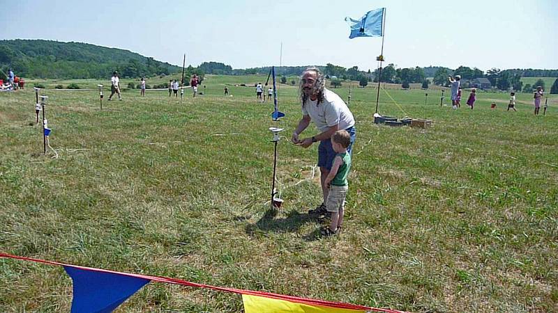 Carl wiring Matthew's rocket.<br />A Central Massachusetts Spacemodeling Society (CMASS) event.<br />July 17, 2010 - Woodsom Farm, Amesbury, Massachusetts.
