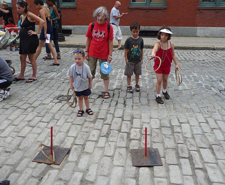 Matthew, Joyce, onlooker, and Miranda.<br />At the Family Activities area.<br />July 24, 2010 - 24th Lowell Folk Festival, Lowell, Massachusetts.