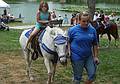 Miranda gets to ride a pony.<br />July 25, 2010 - Yankee Homecoming, Newburyport, Massachusetts.