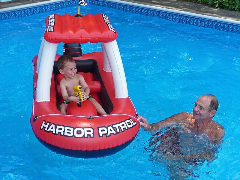 Matthew being entertained by Dominic with a boat that he bought for the kids.<br />July 28, 2010 - At Marie's in Lawrence, Massachusetts.