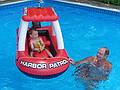 Matthew being entertained by Dominic with a boat that he bought for the kids.<br />July 28, 2010 - At Marie's in Lawrence, Massachusetts.