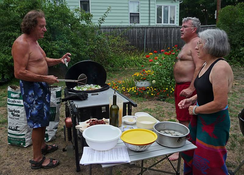 Paul, Jim, and Joyce discussing the finer points of making a paella.<br />August 8, 2010 - At Marie's in Lawrence, Massachusetts.